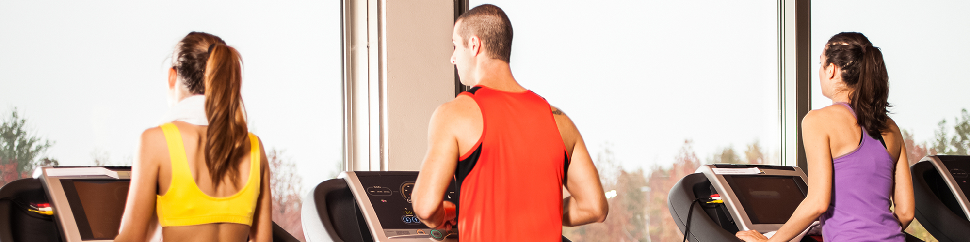 Women and Man Using Treadmills